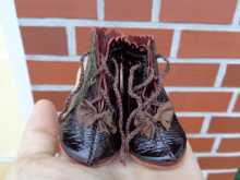 Beautiful doll boots made of leather with ribbons.