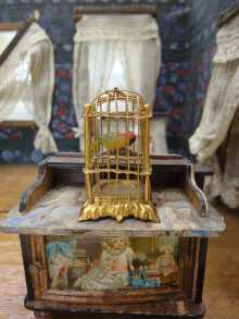 Antique German Erhard & Sohne ormolu bird cage with original wax parrot, dated about 1900.