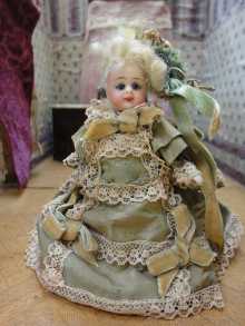 French mignonette doll with closed mouth, dated about 1890.