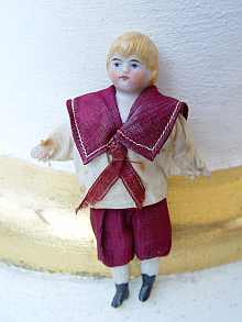 Antique dollhouse bisque doll, a cute little boy, dated about 1900.