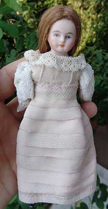 Antique dollhouse doll, a lovely doll maid with old pink dress, dated about 1900.