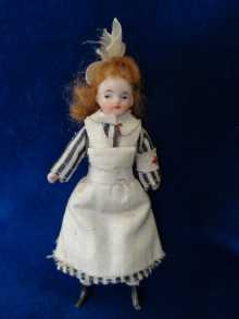 Antique German dollhouse doll, rare bisque nurse, dated about 1900.